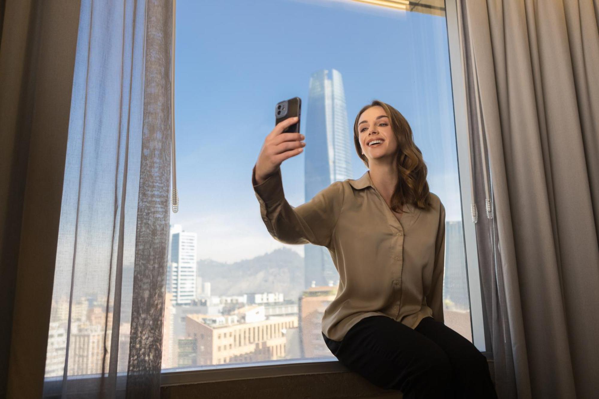 Отель Pullman Santiago El Bosque Экстерьер фото A woman taking a selfie